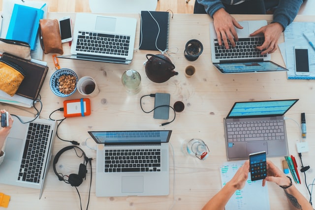 These days, everyone uses the Internet to find products and services. /alt: People using laptops and smartphones. 